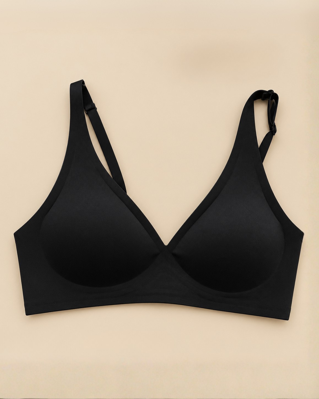 Plunge Lite Bra in black, worn by a model, showing the strap position and low centre