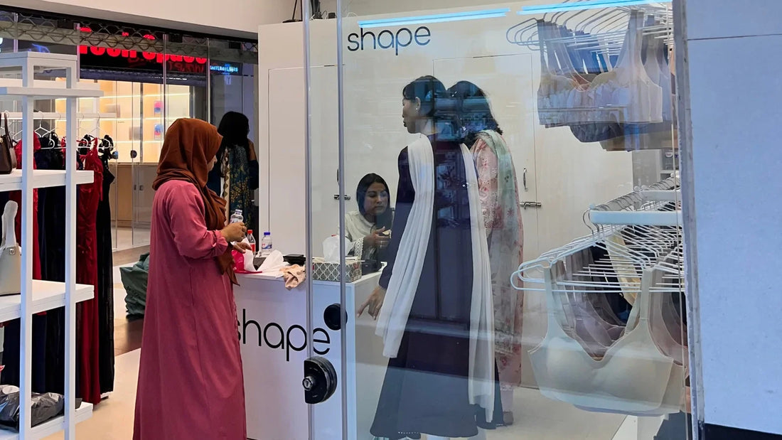 A woman at the counter of SHAPE Lingerie Bashundhara City being helped by a fit advisor